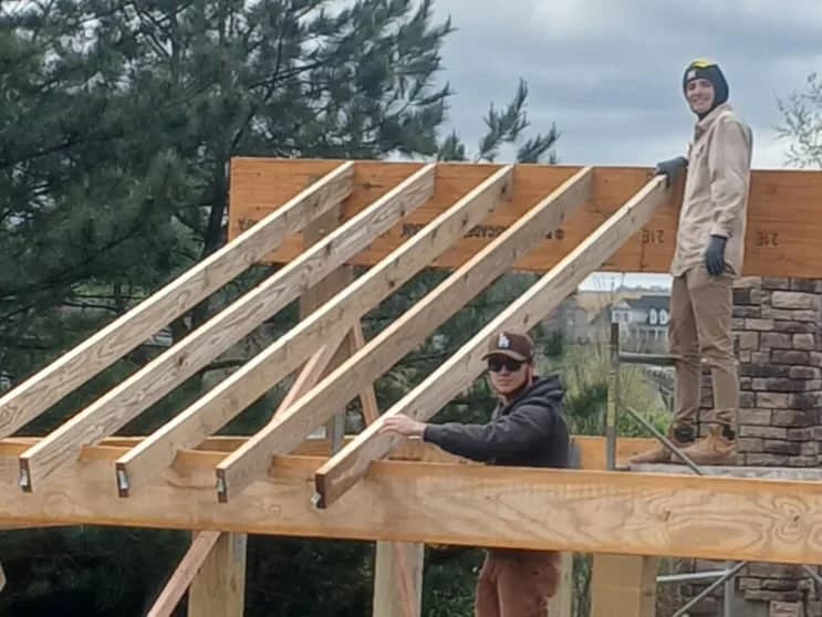 Bluewave crew framing a pergola on a pool project